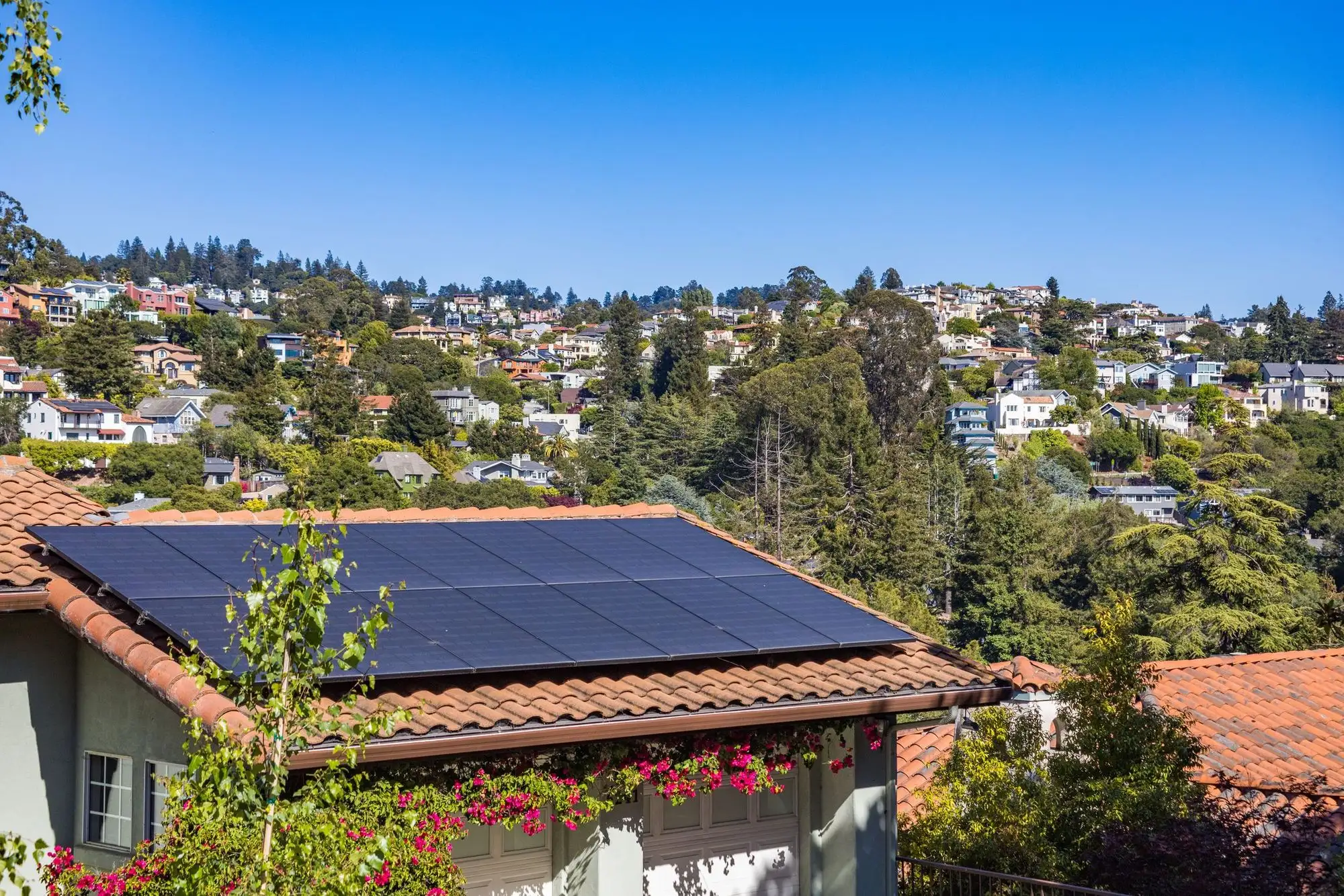 Rooftop solar on a house above a suburb